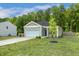Beautiful one-level home featuring an attached garage, green lawn, and serene landscaping at 230 Forest Meadow Ln, Franklinton, NC 27525