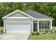 Charming single-story home featuring a two-car garage, manicured lawn, and stone-accented facade at 230 Forest Meadow Ln, Franklinton, NC 27525