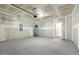 Empty garage featuring ample space, an attached door, and water heater at 230 Forest Meadow Ln, Franklinton, NC 27525