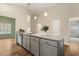 Kitchen island with stainless steel dishwasher and sink, gray cabinets and granite countertops at 230 Forest Meadow Ln, Franklinton, NC 27525