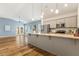 Open concept kitchen featuring gray cabinets, granite countertops, and stainless steel appliances at 230 Forest Meadow Ln, Franklinton, NC 27525