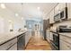 Modern kitchen featuring granite countertops, stainless steel appliances, and hardwood flooring at 230 Forest Meadow Ln, Franklinton, NC 27525