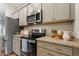 Updated kitchen showcasing stainless steel appliances, granite countertops, and ample cabinet space at 230 Forest Meadow Ln, Franklinton, NC 27525