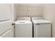 A laundry room with a washer and dryer and wire shelving above at 230 Forest Meadow Ln, Franklinton, NC 27525