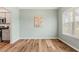 Light-filled room boasts wood floors and seamless transition to the kitchen with stainless appliances at 230 Forest Meadow Ln, Franklinton, NC 27525