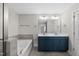 Bathroom showcasing a double vanity with modern sinks, a soaking tub, and a separate glass-enclosed shower at 2407 Miriam Cir, Durham, NC 27704