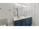 Bathroom featuring double vanity, modern lighting, stylish mirrors and blue cabinet at 2407 Miriam Cir, Durham, NC 27704