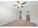 This bedroom features neutral walls, carpet flooring, a ceiling fan, and a closet for storage at 2407 Miriam Cir, Durham, NC 27704