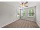 Bedroom with plush carpet, ceiling fan, and multiple windows offering great natural light at 2407 Miriam Cir, Durham, NC 27704