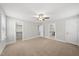 Neutral bedroom with plush carpet, ceiling fan, and en-suite bathroom with walk-in closet at 2407 Miriam Cir, Durham, NC 27704