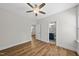 Bedroom with hard surface floors leading to a bathroom with blue vanity at 2407 Miriam Cir, Durham, NC 27704