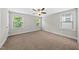Spacious bedroom with plush carpet, three windows and a ceiling fan providing ample natural light at 2407 Miriam Cir, Durham, NC 27704