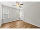 Light and airy bedroom with a ceiling fan, wood-look flooring, and two windows at 2407 Miriam Cir, Durham, NC 27704
