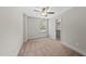 A carpeted bedroom with neutral walls, a ceiling fan and a walk-in closet at 2407 Miriam Cir, Durham, NC 27704