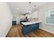Stylish kitchen features a large island with white countertop, modern cabinets, and stainless steel appliances at 2407 Miriam Cir, Durham, NC 27704