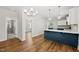 Stylish kitchen with a blue island, pendant lighting, and modern appliances at 2407 Miriam Cir, Durham, NC 27704