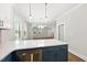 Bright kitchen with white countertops, stainless steel dishwasher and blue cabinetry at 2407 Miriam Cir, Durham, NC 27704