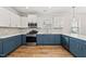 Spacious, updated kitchen features stainless steel appliances, stylish blue lower cabinets, and ample counter space at 2407 Miriam Cir, Durham, NC 27704
