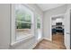 Bright kitchenette with white cabinets, stainless appliances, and hardwood floors offering seamless access to a deck area at 2407 Miriam Cir, Durham, NC 27704