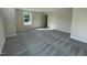 A sunlit bedroom features soft gray carpet and a view through the large window at 253 Busterfield Ct, Benson, NC 27504