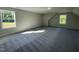 Upstairs bonus room offering plush gray carpeting and two bright windows at 253 Busterfield Ct, Benson, NC 27504