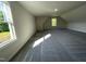 Upstairs bonus room offering plush gray carpeting and bright windows at 253 Busterfield Ct, Benson, NC 27504
