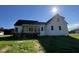 The exterior of the two-story home features white siding, black roof, and wooden porches at 253 Busterfield Ct, Benson, NC 27504