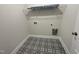 Laundry room with black and white patterned floor, utility connections, and overhead shelf at 253 Busterfield Ct, Benson, NC 27504