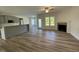 Open-concept living area featuring wood floors, a fireplace, and natural light at 253 Busterfield Ct, Benson, NC 27504