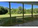 A screened porch overlooks a large grassy yard surrounded by a lush green forest at 253 Busterfield Ct, Benson, NC 27504