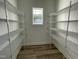 Spacious walk-in closet featuring ample shelving for storage at 253 Busterfield Ct, Benson, NC 27504