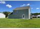 The home features an expansive backyard and green lawn with a modern neutral-color exterior at 253 Lotus Ave, Smithfield, NC 27577