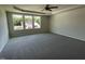A spacious main bedroom features large windows that provide natural light and neutral carpet flooring at 253 Lotus Ave, Smithfield, NC 27577