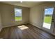 Sunny bedroom featuring wood-look floors and a view of the outdoors at 253 Lotus Ave, Smithfield, NC 27577
