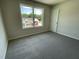 Carpeted bedroom with a window view of the neighborhood and a white painted door at 253 Lotus Ave, Smithfield, NC 27577
