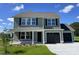 Charming two-story home with a manicured lawn, black shutters and a two-car garage at 253 Lotus Ave, Smithfield, NC 27577