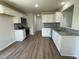 Modern kitchen with white cabinets, stainless steel appliances and beautiful wood-look flooring at 253 Lotus Ave, Smithfield, NC 27577