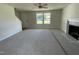 Open-concept living room with plush carpeting, a fireplace and ample natural light at 253 Lotus Ave, Smithfield, NC 27577