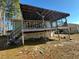Covered back deck with wood railing and stairs to the backyard at 302 N 12Th St, Erwin, NC 28339