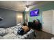 Bedroom features a ceiling fan, TV, and closet at 302 N 12Th St, Erwin, NC 28339