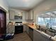 Kitchen with gray cabinets, wood countertops, and stainless steel sink at 302 N 12Th St, Erwin, NC 28339