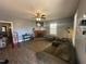 Living room featuring a fireplace, tv, ceiling fan and wood floors at 302 N 12Th St, Erwin, NC 28339