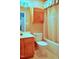 Well-lit bathroom featuring a tub with shower, toilet, and a wooden vanity with cabinet at 3027 Maple Ave # Apt K3, Burlington, NC 27215