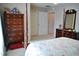 Spacious bedroom featuring a four-poster bed, closet, and matching wood furniture at 3027 Maple Ave # Apt K3, Burlington, NC 27215
