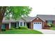 Charming home with a brick facade, well-maintained landscaping, and an attached one car garage at 3027 Maple Ave # Apt K3, Burlington, NC 27215