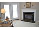 Elegant fireplace with white mantel, black marble surround, and French doors at 3027 Maple Ave # Apt K3, Burlington, NC 27215