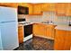 Classic kitchen featuring wooden cabinets, modern appliances, and a patterned floor at 3027 Maple Ave # Apt K3, Burlington, NC 27215