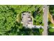 Aerial view of charming home featuring a deck, a driveway, and a basketball court at 304 Villa Dr, Durham, NC 27712