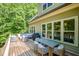 Large back deck featuring a grill and outdoor dining area with wooded views at 304 Villa Dr, Durham, NC 27712