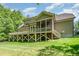 View of the home's elevated deck, screened in porch, and well-manicured lawn at 304 Villa Dr, Durham, NC 27712